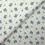 Jersey de coton matelassé imprimé fleurettes bleu fond blanc