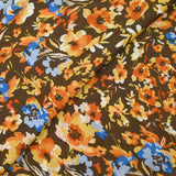 Mousseline crinkle satinée tableau de fleurs jaunes et bleues fond marron