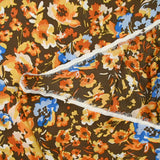 Mousseline crinkle satinée tableau de fleurs jaunes et bleues fond marron