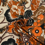 Jersey de viscose imprimé champ de fleurs orange et marron fond beige