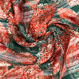 Green and orange pointillism satin band printed muslin