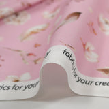 Cretonne de coton imprimé plume et fleur fond rose