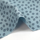 Punto de algodón estampado hojas fondo azul cielo