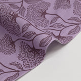 Popelina de algodón estampada con gráfico de flores fondo morado