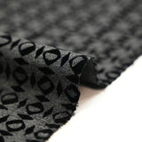Maille Milano polyester géométrique floqué velours noir fond gris anthracite