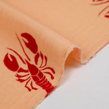 Double gauze printed with red lobster and apricot background