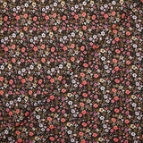Digital printed cotton voile meadow of small orange and butter yellow flowers on a black background