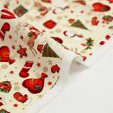 Cotton poplin printed with reindeer, snowmen and gifts on an ecru background