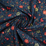 Cotton poplin printed with poinsettias and red bows on a navy blue background