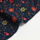 Cotton poplin printed with poinsettias and red bows on a navy blue background
