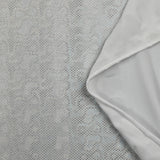 Jersey printed with holographic silver polka dots on white background