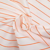 Sergé de polyester rayures brodées orange fond blanc