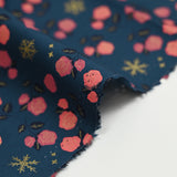 Cotton poplin printed with coral roses and gold flakes on a steel blue background