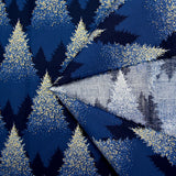 Cotton poplin printed with sparkling fir trees on a midnight blue background