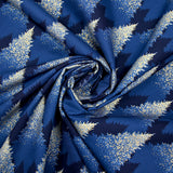 Cotton poplin printed with sparkling fir trees on a midnight blue background