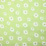 Double gauze printed with daisy smiley face, apple green background