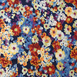 Maille crêpe imprimée fleurs bleu, orange et violet fond marine