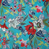 Mousseline imprimée fleurs exotiques rouge et blanc fond turquoise