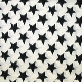Satin polyester étoiles noires fond blanc cassé