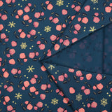 Cotton poplin printed with coral roses and gold flakes on a steel blue background