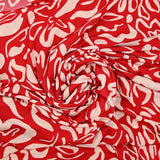 Jersey de polyester imprimé formes de fleurs écru fond rouge