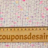 Tweed de laine mélangée confettis rose et bleu fond violet