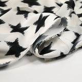 Black stars polyester satin broken white background