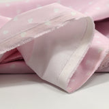 Piqué de coton imprimé cœur fond rose clair
