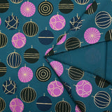 Cotton poplin printed with festive balls and golden flashes on a duck background