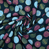 Cotton poplin printed with festive balls and golden sparkles on a navy blue background