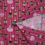 Cotton poplin printed with vintage Christmas baubles on a purple background