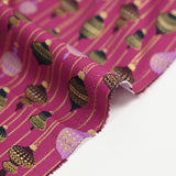 Cotton poplin printed with vintage Christmas baubles on a purple background