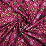 Cotton poplin printed with vintage Christmas baubles on a purple background