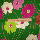 Viscose twill printed with anise and fuchsia flowers on a meadow green background