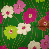Viscose twill printed with anise and fuchsia flowers on a meadow green background