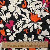 Fine viscose satin printed with fuchsia, orange and ecru royal flowers on a black background