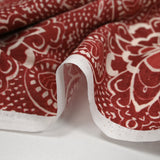 Tejido de algodón con aspecto de lino y estampado arabesco rojo ladrillo.