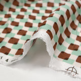 Viscose satin with brown and mint superimposed check print on an ecru background