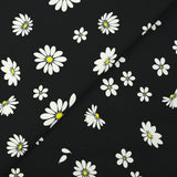 Cotton gabardine with daisy print on black background