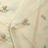 Polyester satin embroidered peach flowers ivory background