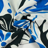 Cotton voile with blue and black arabesque print on white background