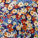 Maille crêpe imprimée fleurs bleu, orange et violet fond marine