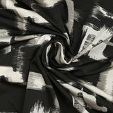 Jersey imprimé illusion grège et blanc cassé fond noir