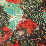 Maille crêpe imprimée patchwork ethnique rouge corail fond marron