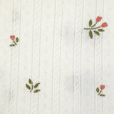 Punto pointelle de algodón con estampado de tulipanes, fondo blanquecino