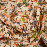 Viscose linen printed with blush and purple pansy flowers on an ecru background