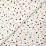 Jersey pointelle coton imprimé envolée de fleurs rose et brique fond blanc cassé