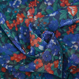 Maille polyester lamée fleurs bleu et rouge fond marine