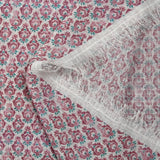 Textured muslin printed with purple and turquoise floral medallions on a white background