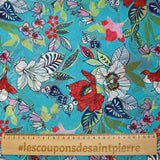 Muslin printed with exotic red and white flowers on a turquoise background